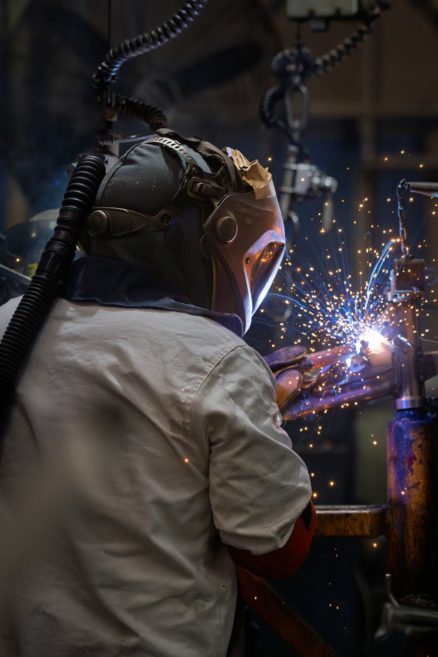 industrial welder in action with sparks flying
